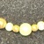 14K YELLOW GOLD BOX LINK CHAIN WITH GOLD AND PEARL LIKE BEADS. 30 INCHES LONG.